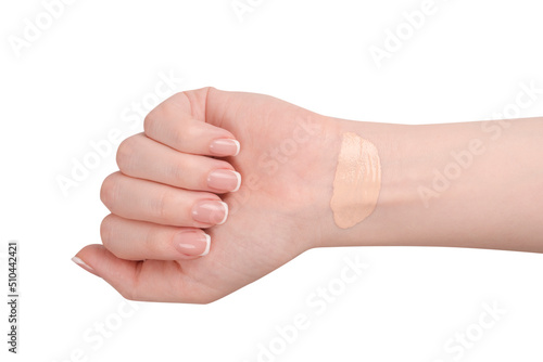 Swatch of foundation on a woman hand isolated on white background.