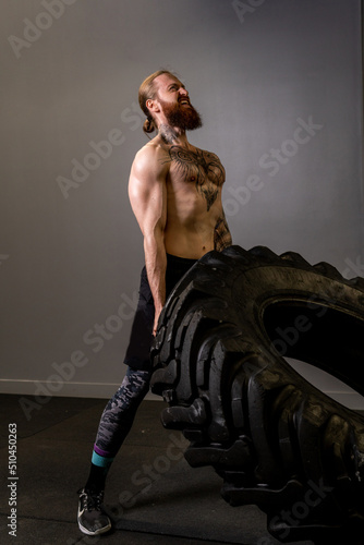 Fitness flipping crossfit young training wheel tire gym heavy push, for strength workout for fit and athlete caucasian, flip bodybuilder. Full energy force,