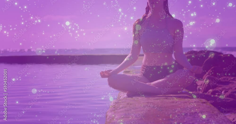 Animation of lights and connections over caucasian woman practicing yoga on beach Animation of lights and connections over caucasian woman practicing yoga on beach