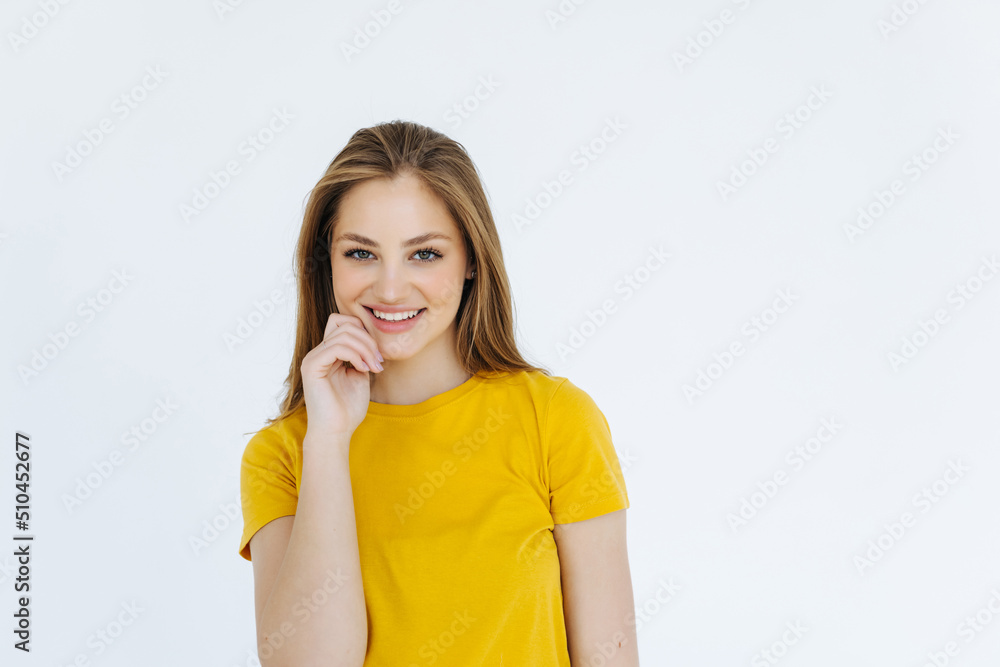 Beautiful young student in red trendy sweater smiling and holding her hand on chin, isolated over white background. Beautiful young student in red trendy sweater smiling and holding her hand on chin, isolated over white background.