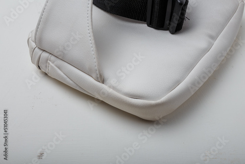 Eco leather waist bag with black zipper on white background, close up shot photo