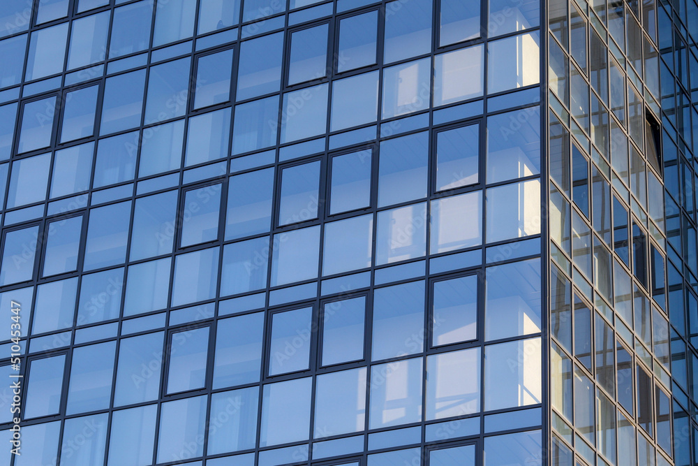 Glass office building, view of the sky reflected in the windows. Concept for work, business, offices. Copy space Glass office building, view of the sky reflected in the windows. Concept for work, business, offices. Copy space