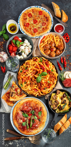Italian food assortment on dark background.