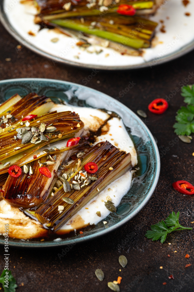 Sweet and sour braised leeks over whipped feta cheese, vegetarian vegan summer Asian style food concept