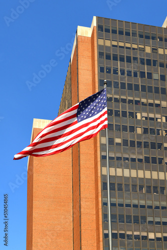 American flag on background of James A. Byrne United States Courthouse, Federal courthouse in Center City region of Philadelphia photo
