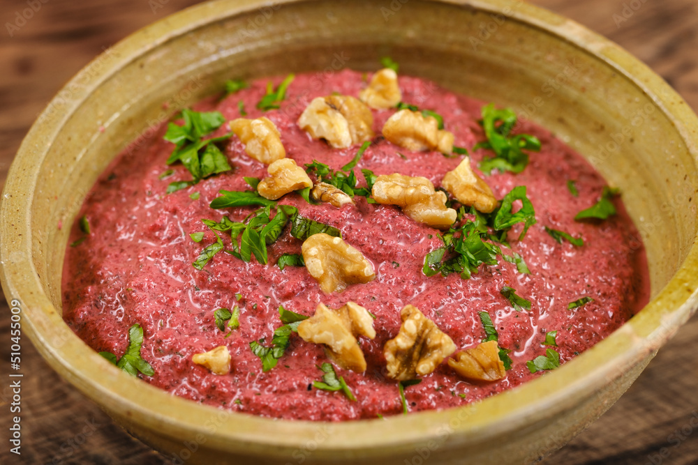 healthy homemade beetroot dip sauce hummus, in rustic clay bowl served with walnuts and parsley healthy homemade beetroot dip sauce hummus, in rustic clay bowl served with walnuts and parsley