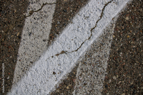 Three white painted stripes from the race track