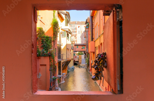 Fototapeta Naklejka Na Ścianę i Meble -  Secret window in the wall to the hidden part of the city in Bologna, Italy. Canal of Reno in Piella street
