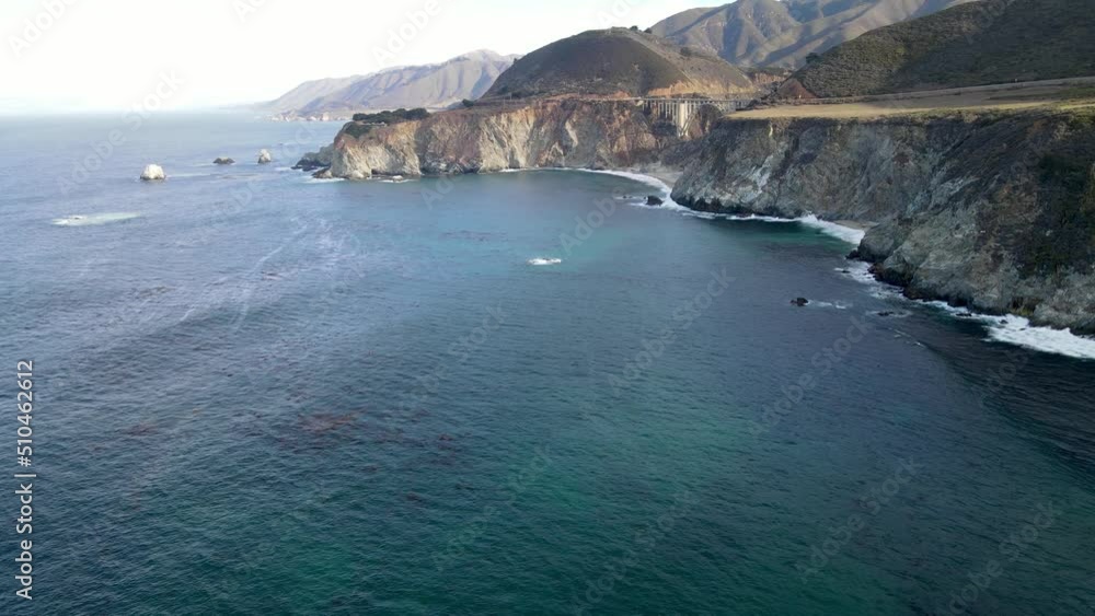Aerial of the rugged coastline of Big Sur California. The Pacific Coast Highway and the famous Bixby Creek Bridge can be seen. Aerial of the rugged coastline of Big Sur California. The Pacific Coast Highway and the famous Bixby Creek Bridge can be seen.