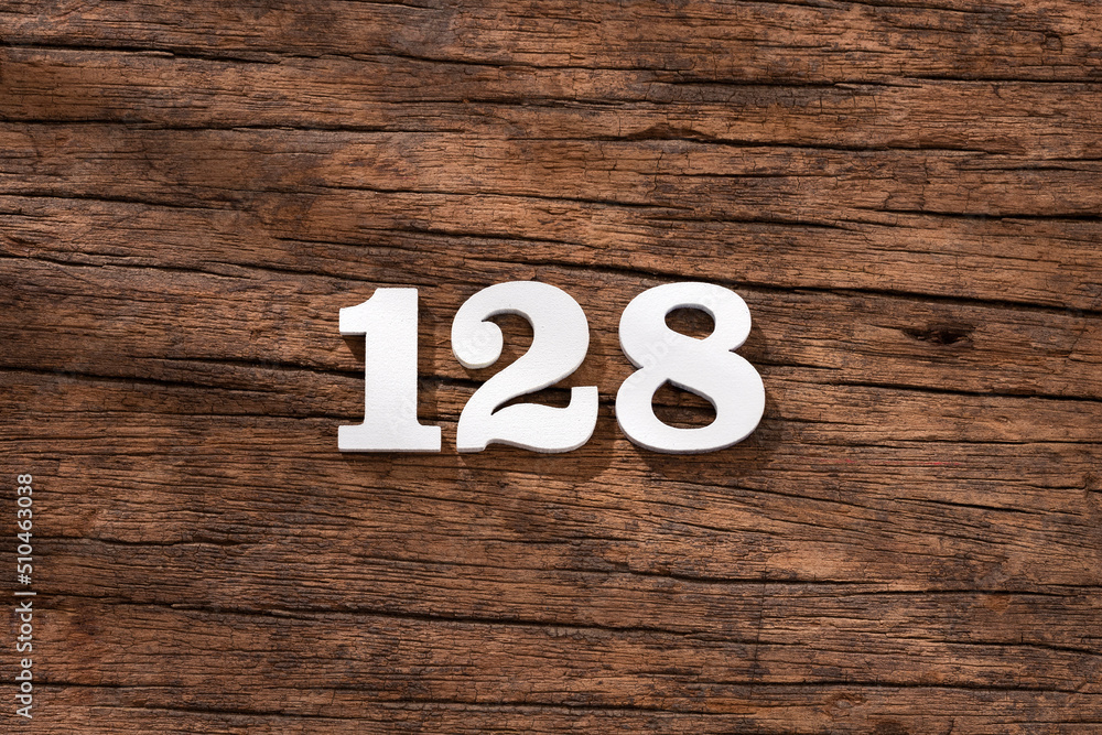 Number 128 - piece on rustic wood background Number 128 - piece on rustic wood background