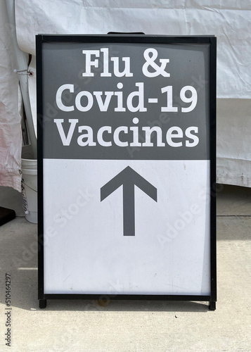 Fototapeta Naklejka Na Ścianę i Meble -  Outdoor poster for Flu and Covid-19 vaccines at a health clinic