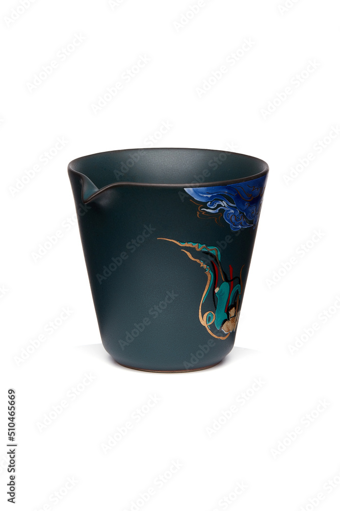 Detailed shot of a dark turquoise color printed chahai in chinese style. The designer ceramic hand painted chahay with a mythological image is isolated on the white background. Detailed shot of a dark turquoise color printed chahai in chinese style. The designer ceramic hand painted chahay with a mythological image is isolated on the white background.