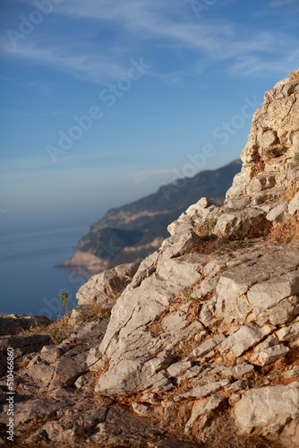  Beautiful evening landscape in the mountains. Sunset. Rocks, sea, blue sky.