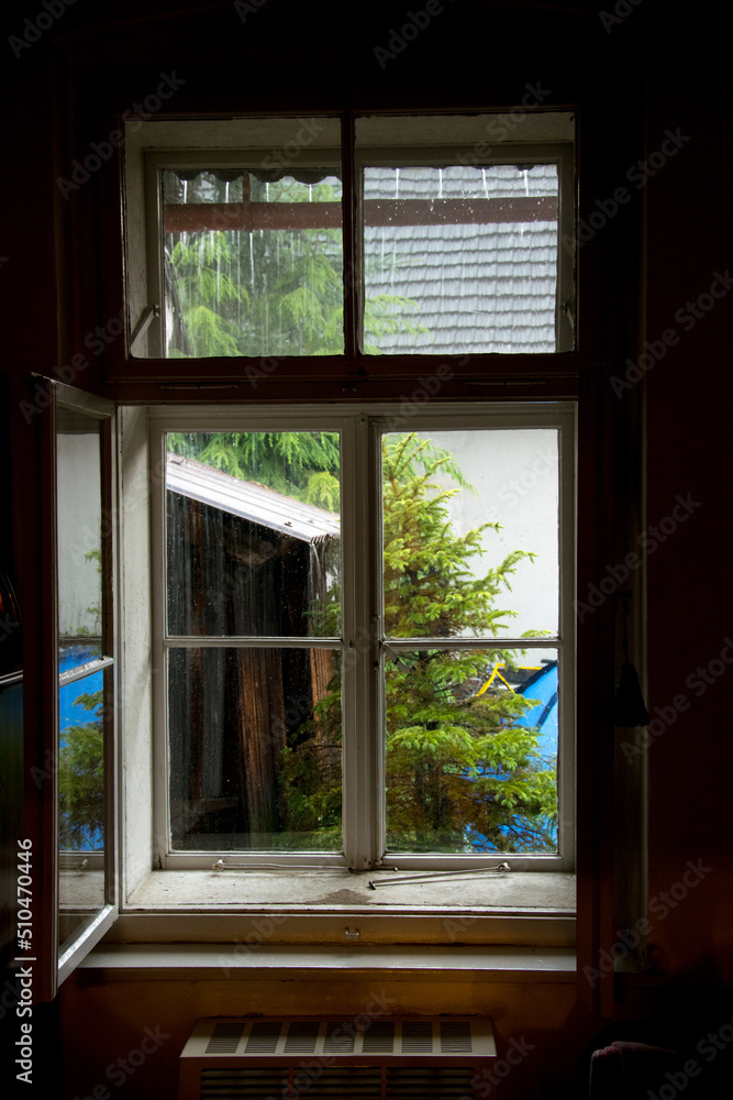 A view of rain from a wooden window of an old cottage A view of rain from a wooden window of an old cottage