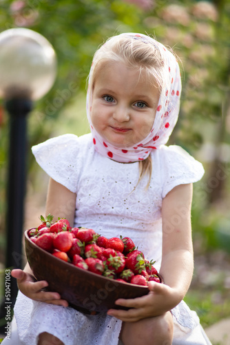 little child eating strawberries