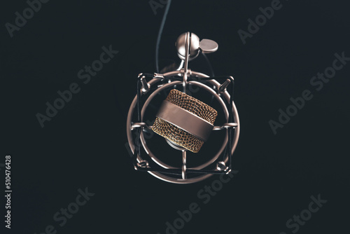 Close up of vintage microphone on a black background.