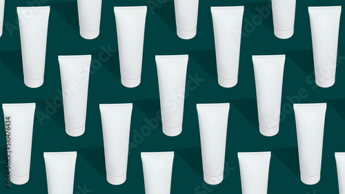 Pattern from mock up cosmetic or toothpaste tubes on green background