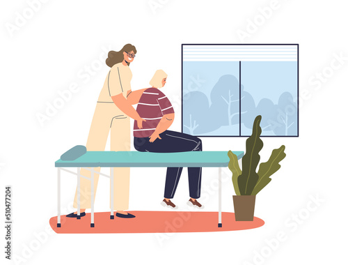 Female masseur massaging woman patient on table. Manual osteopath therapist work on spine and back