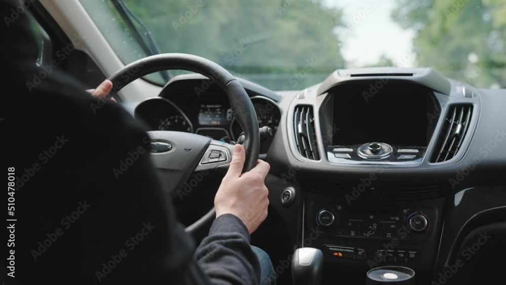 Man drives a car along the road during the rain Man drives a car along the road during the rain