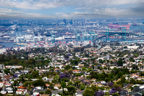 Panorama Long Beach, California skyline and city scape of international port, shipping, cranes, urban homes and surrounding and industrial area.