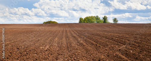 Plowed field and blue sky. agriculture plowed field and blue sky with clouds. photo