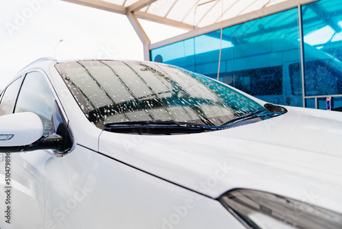 wet white car. self-service car wash. car washer.