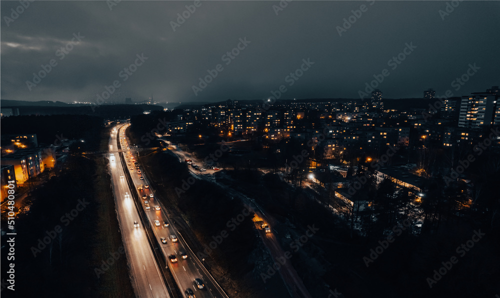 Multi-lane road in the European city Vilnius at night from aerial perspective in Lithuania