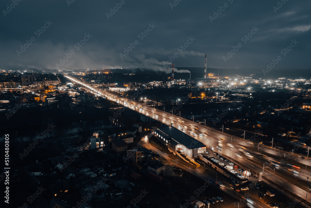 Multi-lane road in the European city Vilnius at night from aerial perspective in Lithuania