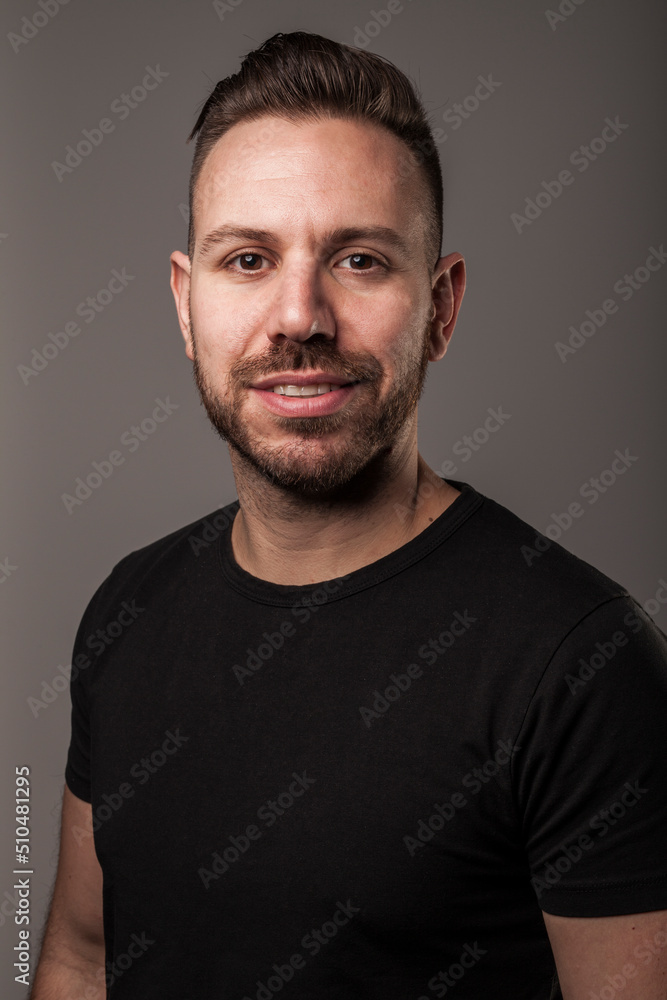 Portrait of young man smiling in studio