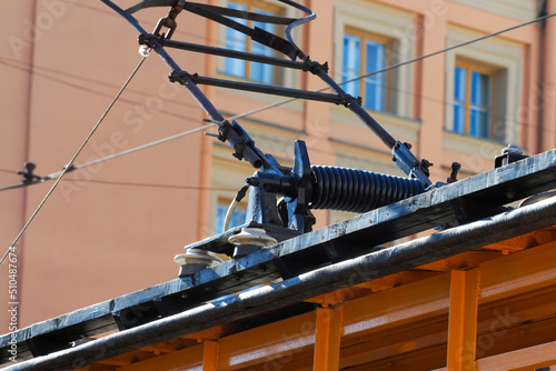 Old retro tram pantograph. Contact network designed to transmit electricity from traction substations to electric rolling stock. Vintage transport background