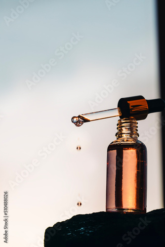 Drops of facial serum with pipette 