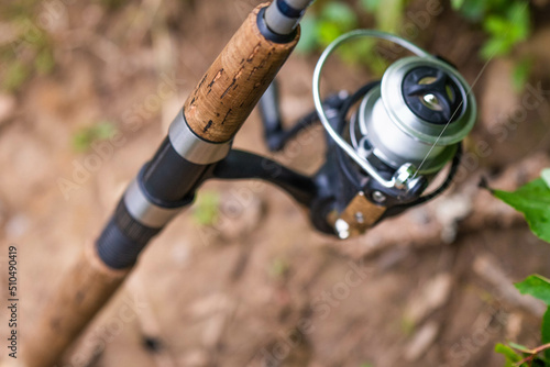 Fishing reel and fishing line close up, summer fishing, leisure activity.