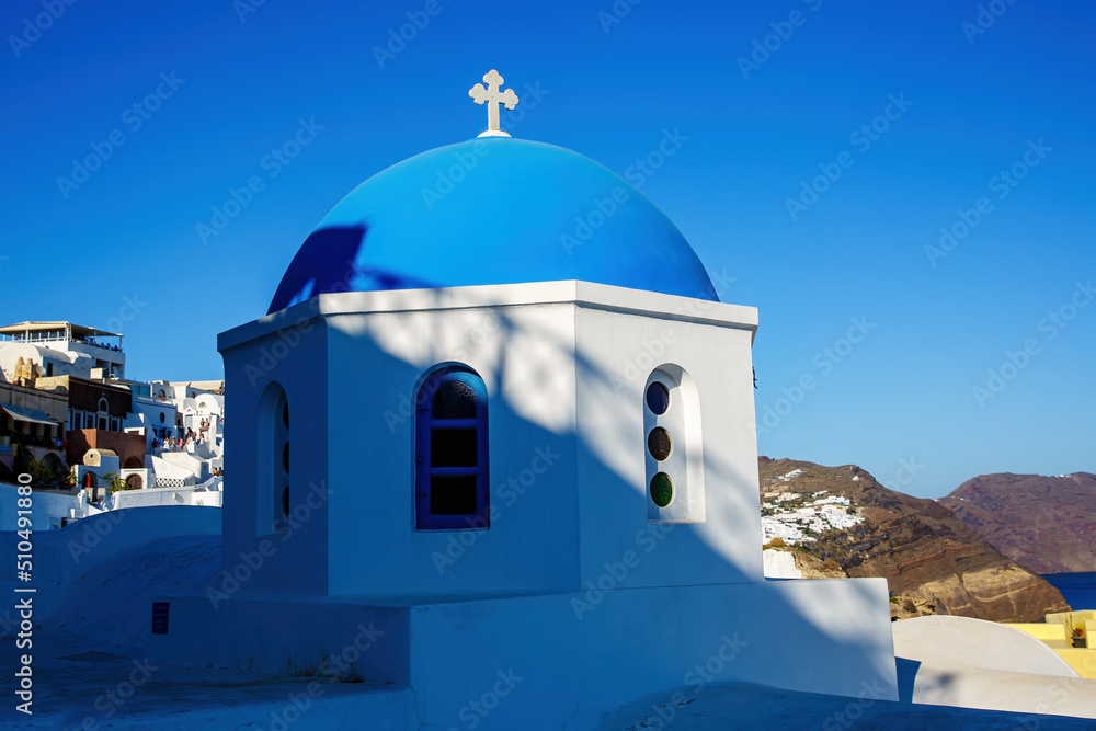 Oia church with cupola painted blue, Santorini island in Greece.