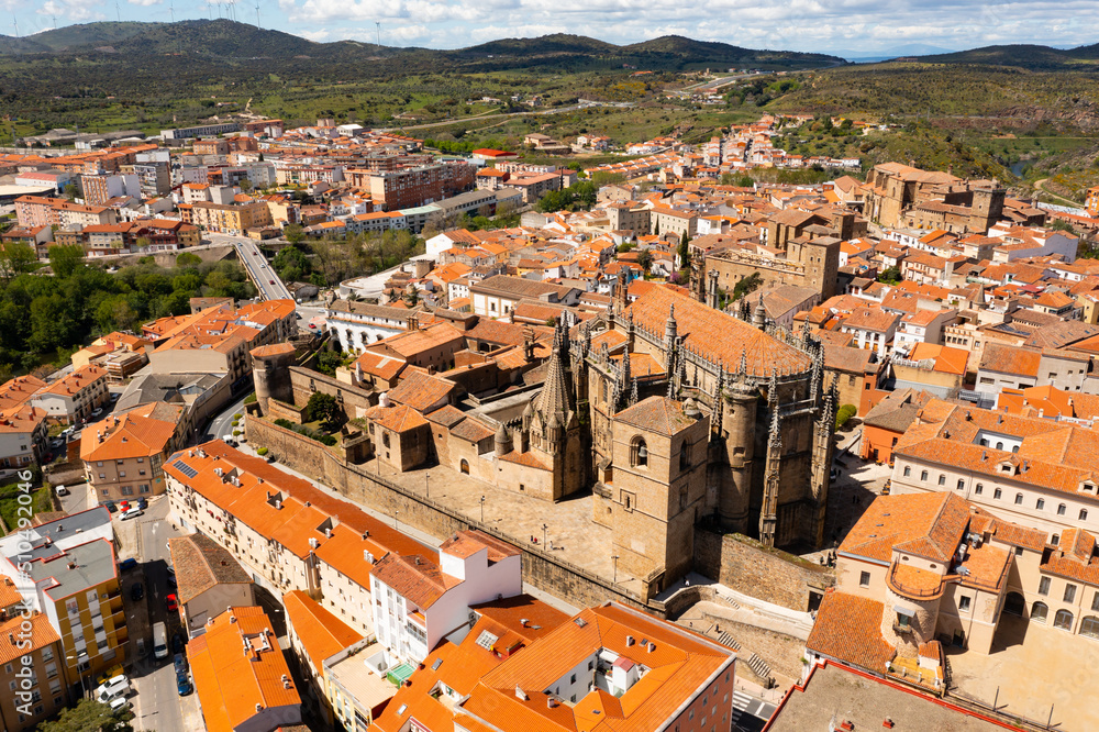 Bird's eye view of residential buildings with tiled roofs and cathedral in Plasencia, Extremadura, Spain.