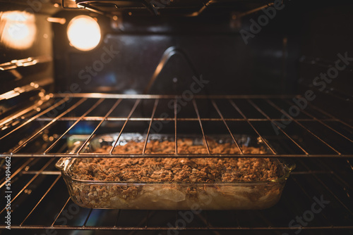 Apple crisp in a glass pan, freshly baked, sitting in an oven