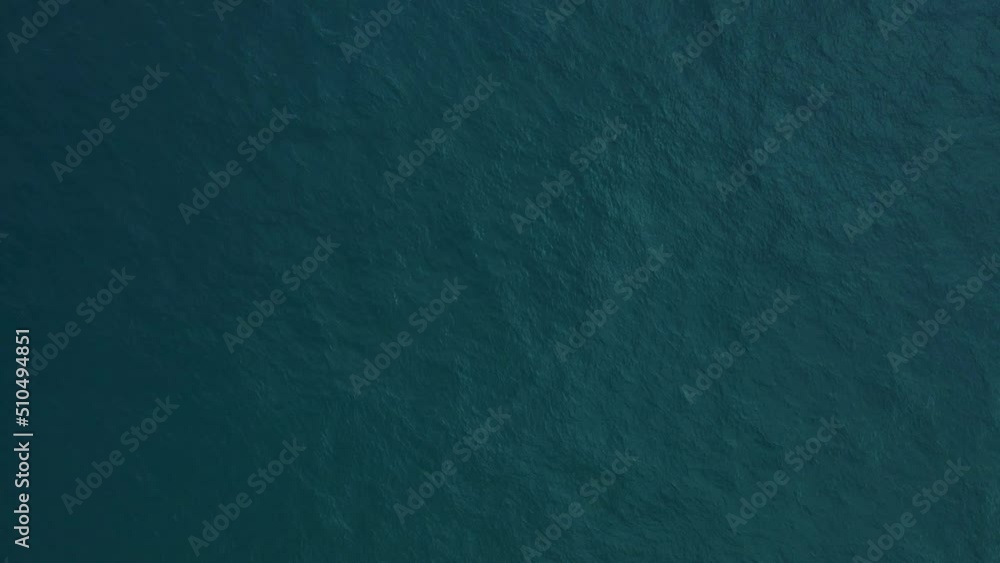 Aerial view top-down of blue water surface Aerial view top-down of blue water surface