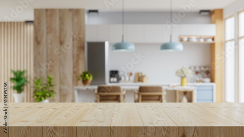 Wooden table top on blur kitchen room background,Modern Contemporary kitchen room interior. photo