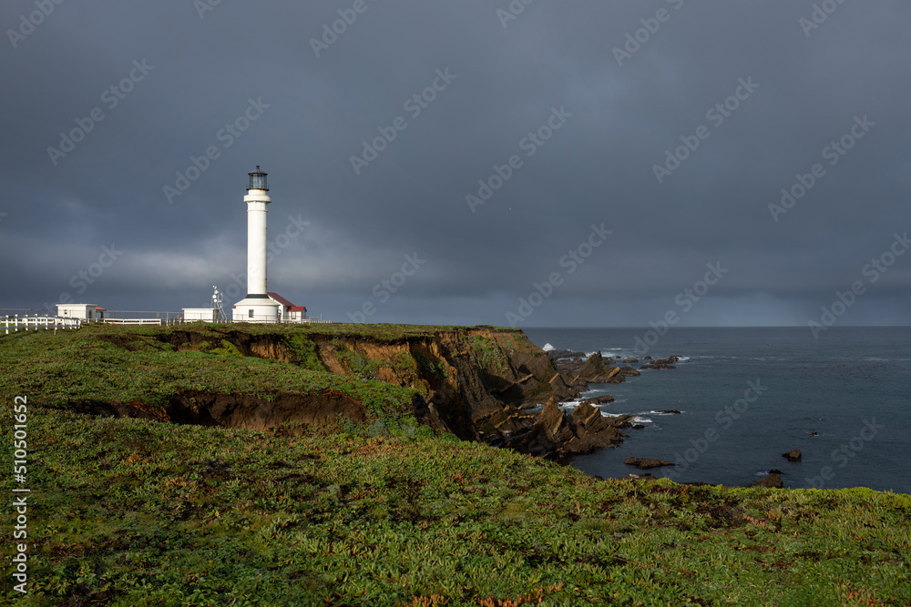 Point Arena Lighthouse on beautiful cliffs, California, USA, stormy sky