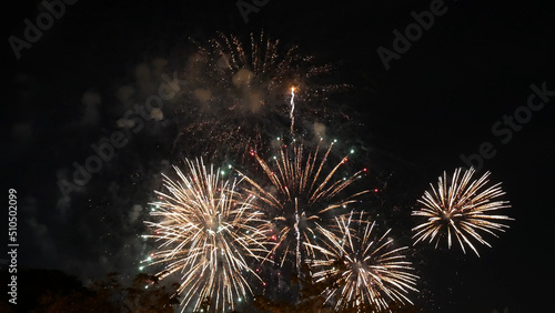 Golden Firework celebrate anniversary happy new year 2023  4th of july holiday festival. Gold firework in the night time celebrate national holiday. Countdown to new year 2022 gold party time event