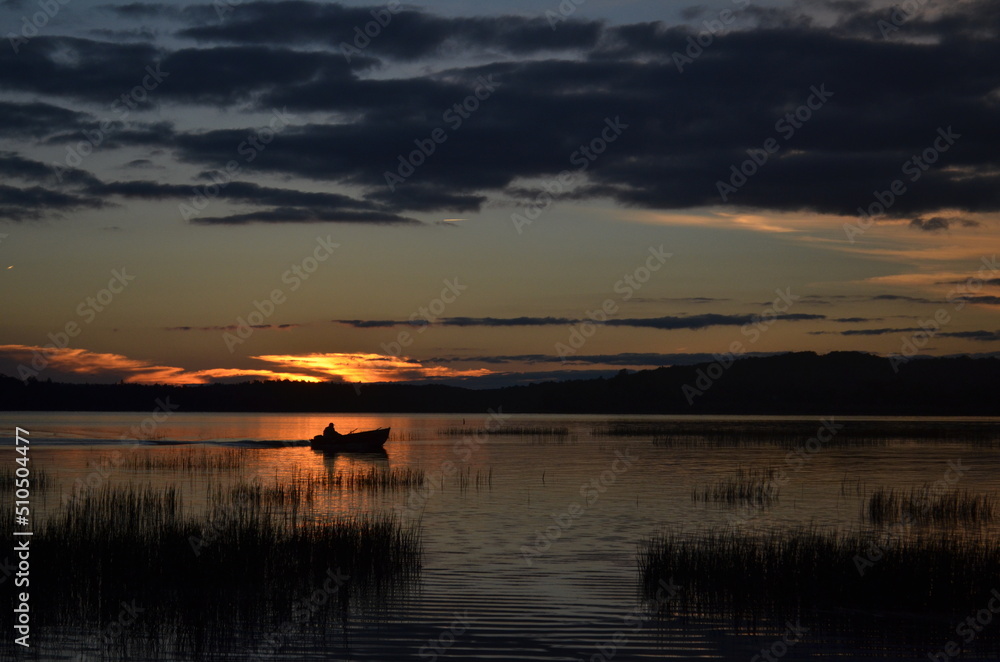 sunset over Tupper Lake with row boat