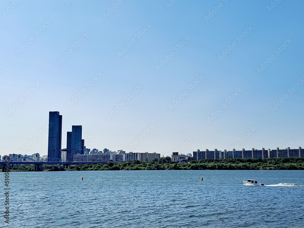 Dynamic boat tour on the Han River and panoramic view of high rise modern buildings in Seoul