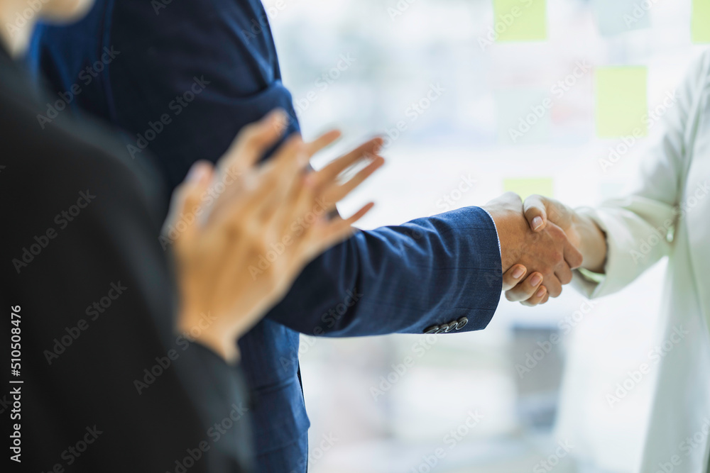 Business people shake hands while finishing up meetings or negotiations in the office. Congratulations handshake for new employees Business handshake and partnership concepts.