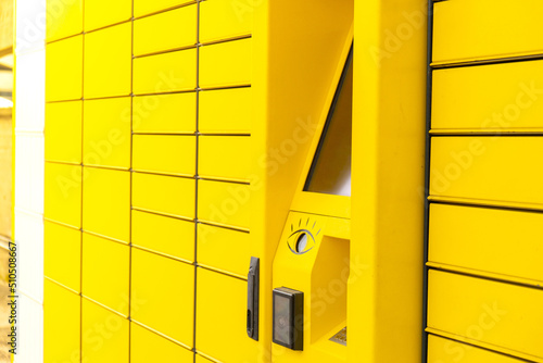 Modern yellow shopping locker. Bar code reader for Skans QR Code on Mobile phone Self-service Locker Cell Modern Shipping and Delivery Concept with Contactless Automated Postal Box. Parcel Locker photo