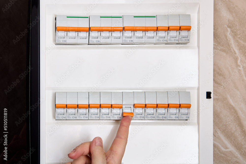 Switching on circuit breaker on panel board it has tripped due to overcurrent. Stock Photo