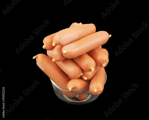 Many sausages in glass bowl isolated on black background.