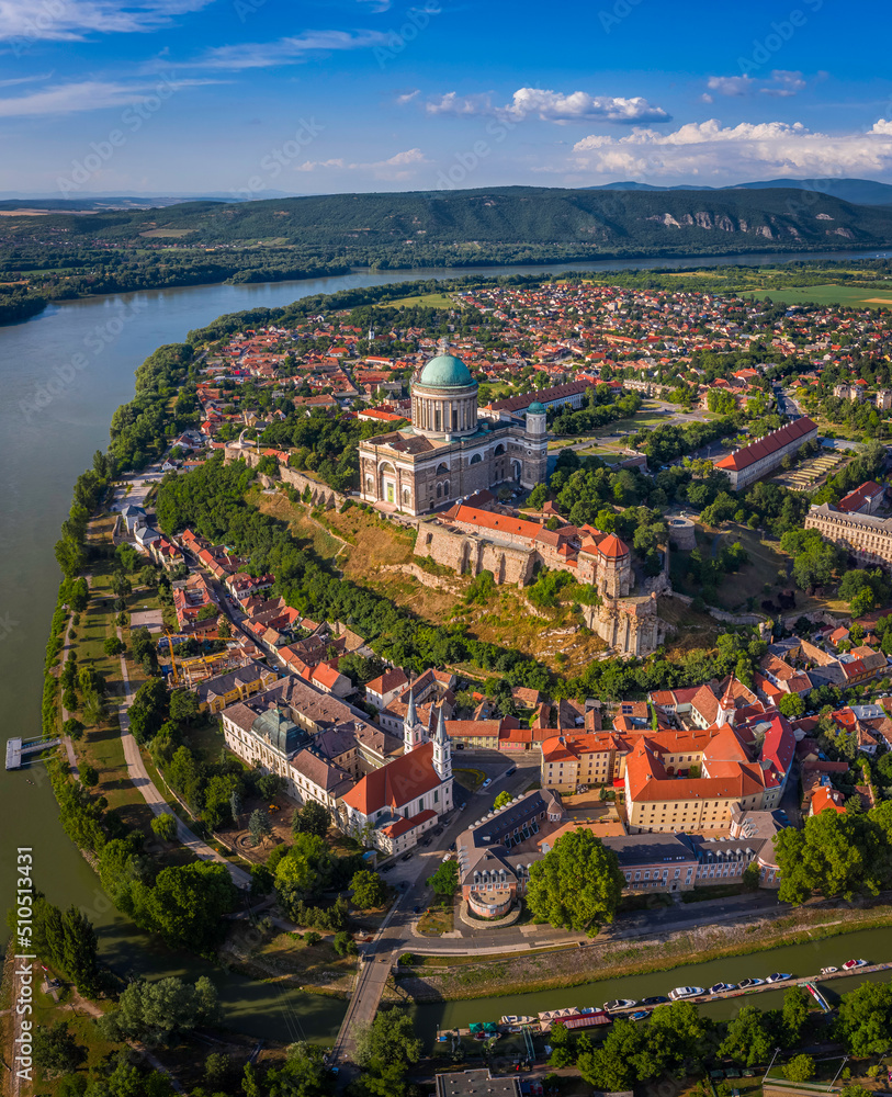 Esztergom, Hungary - Aerial panoramic view of Primatial Basilica of the Blessed Virgin Mary Assumed Into Heaven (Basilica of Esztergom) on a summer day with blue clouds and River Danube at background