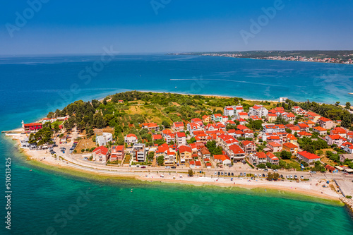 Zadar, Croatia - Aerial view of Puntamika beach with red rooftops, clear blue sky and turquoise Adriatic sea water on a sunny summer day in the city of Zadar photo