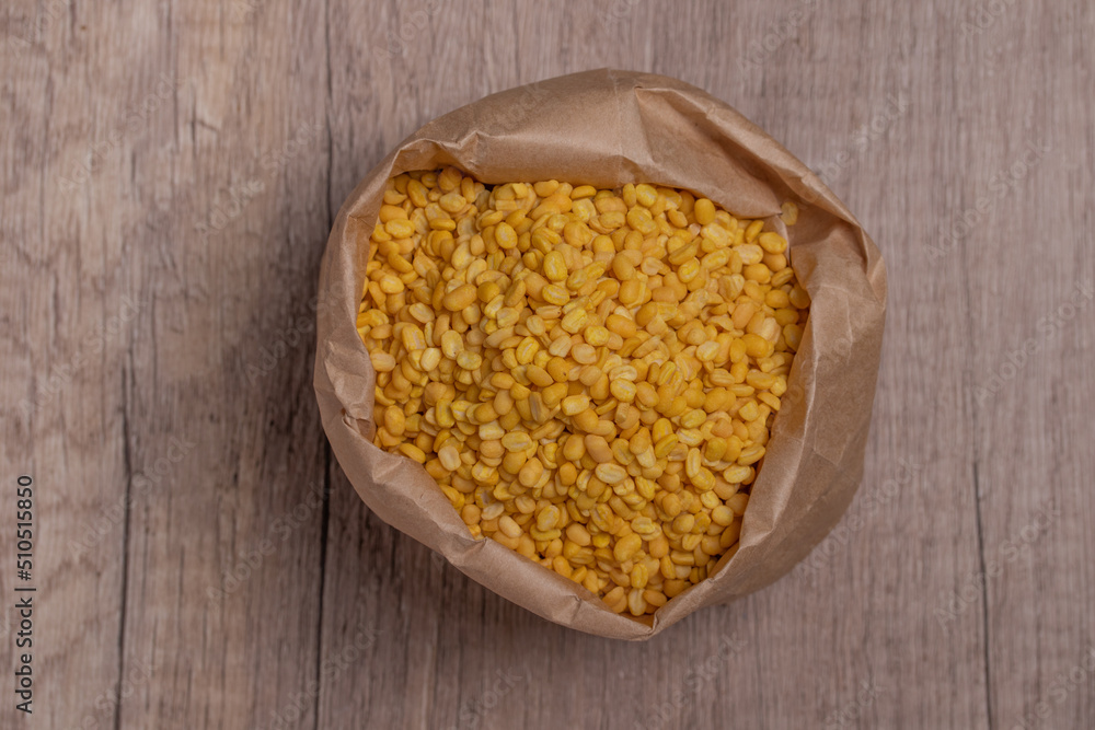 Whole grains of soybeans in paper bags on wooden floor Whole grains of soybeans in paper bags on wooden floor