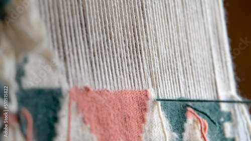 Close up, A woman weaving traditional handmade carpet. Turkish carpet weaving, a female hands weaving a carpet, rug. Needlework. Carpet-makers work. 4k, slow motion footage with natural sound effect.