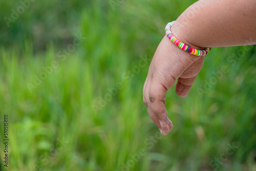 Rainbow bracelet on green background.lgbt concept. happy earth day.copy space © mangolovemom